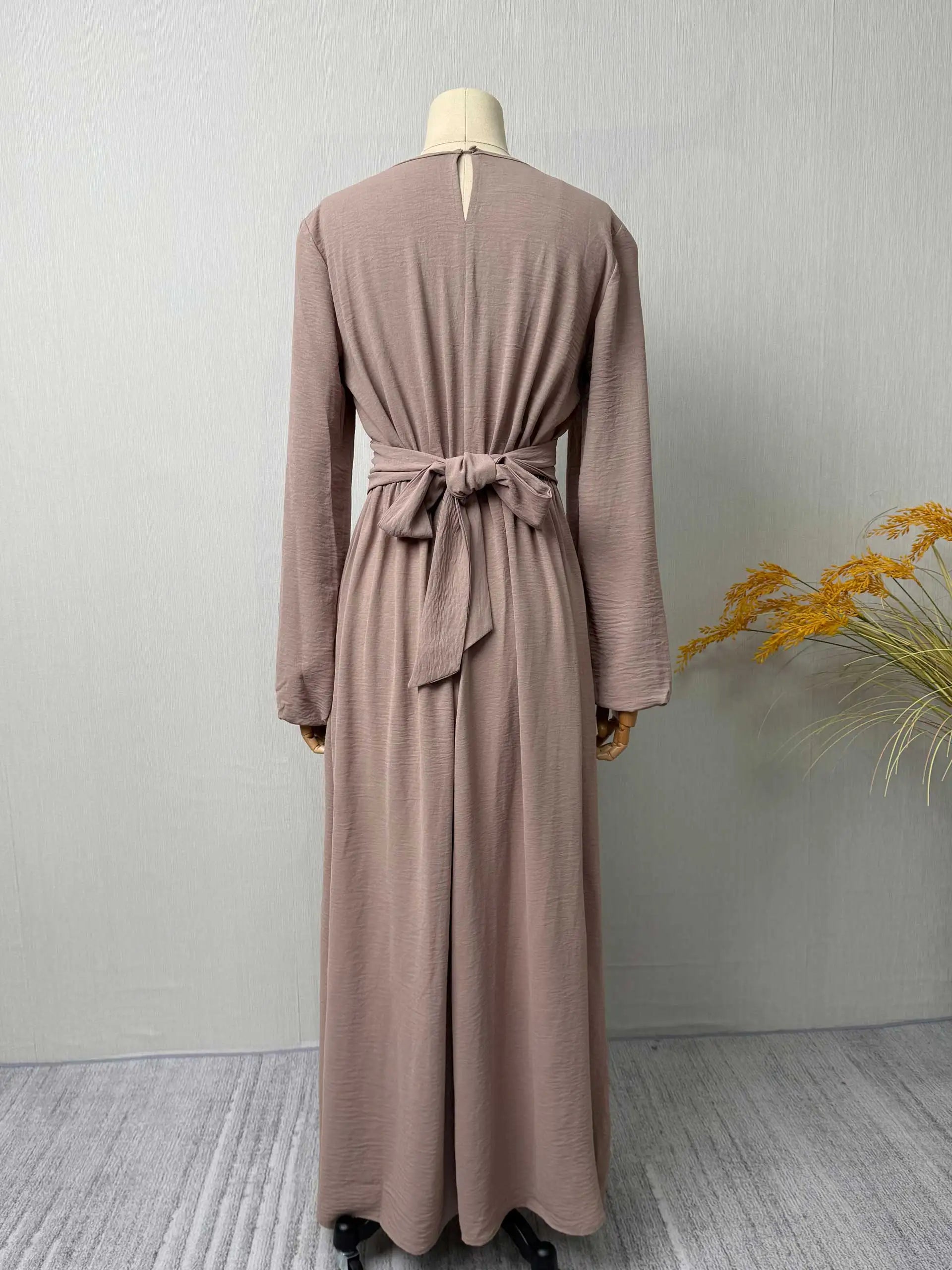 Trendy Modest Dress in Cream Tone Cross Neck and Waist Binding Design Great for Modern Islamic Women's Daily and Occasional Wear