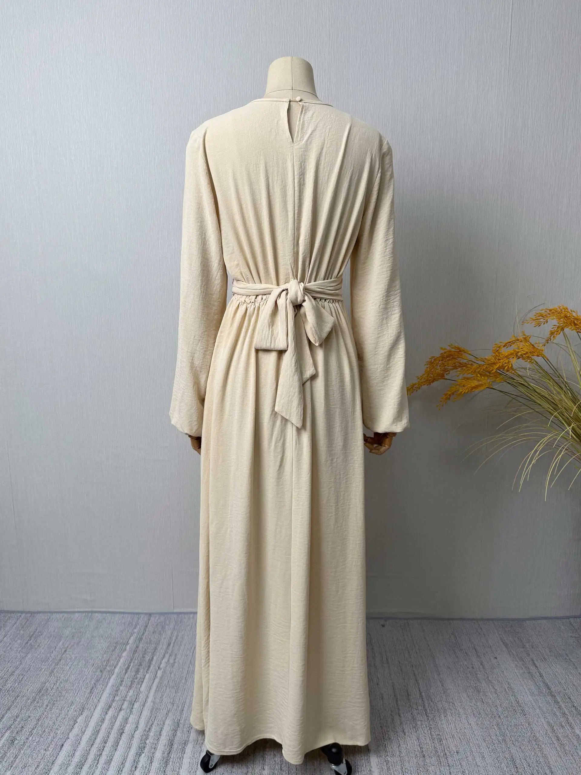 Trendy Modest Dress in Cream Tone Cross Neck and Waist Binding Design Great for Modern Islamic Women's Daily and Occasional Wear