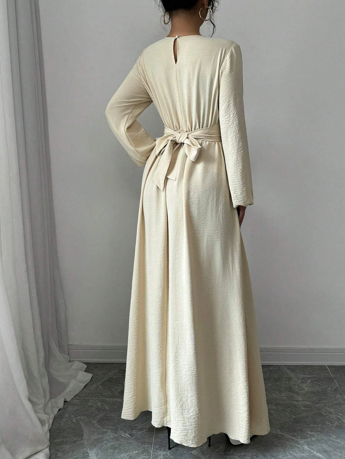 Trendy Modest Dress in Cream Tone Cross Neck and Waist Binding Design Great for Modern Islamic Women's Daily and Occasional Wear