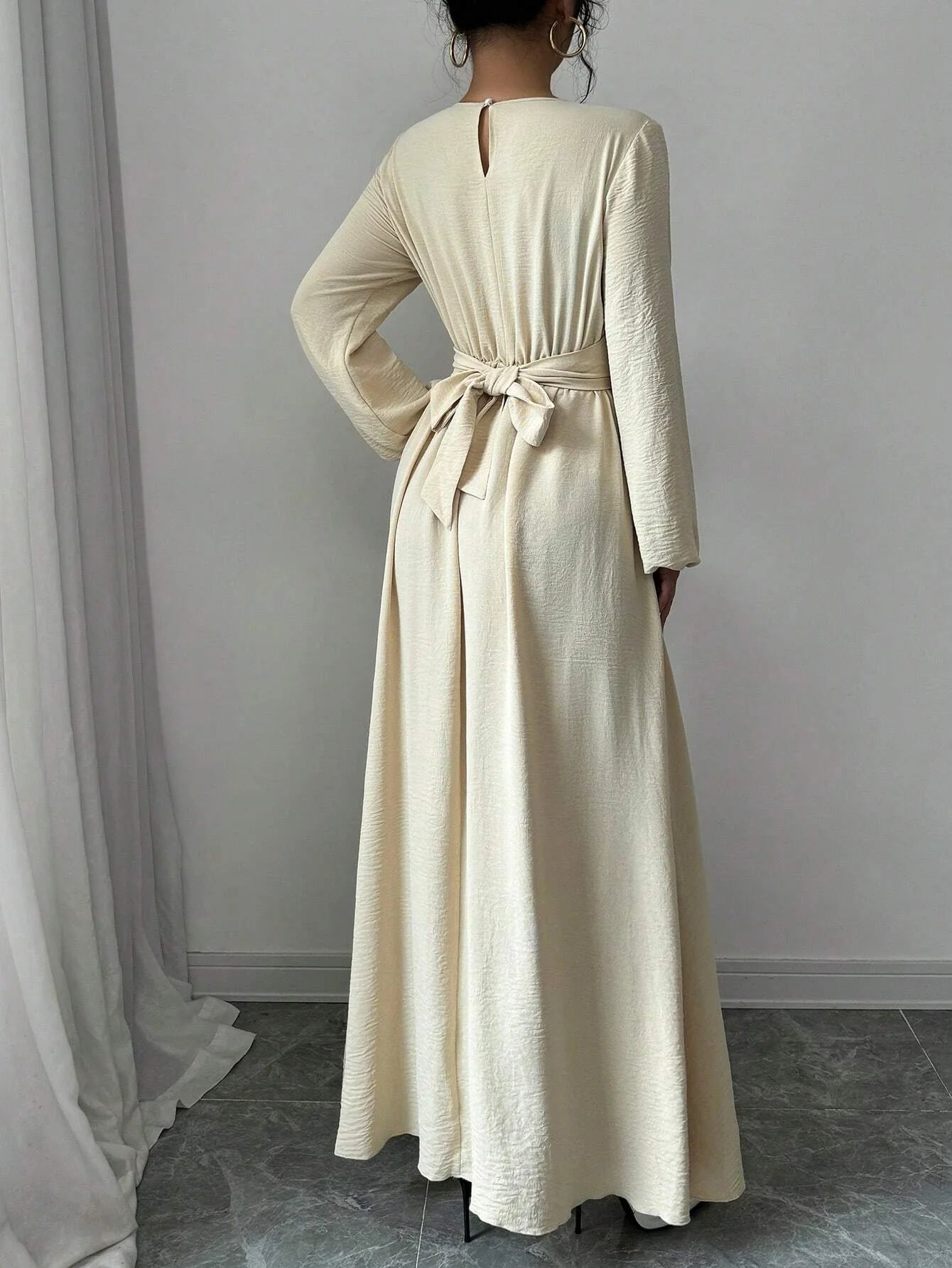 Trendy Modest Dress in Cream Tone Cross Neck and Waist Binding Design Great for Modern Islamic Women's Daily and Occasional Wear
